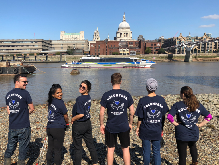 Blue State's London team posing in front of river for Volunteer day