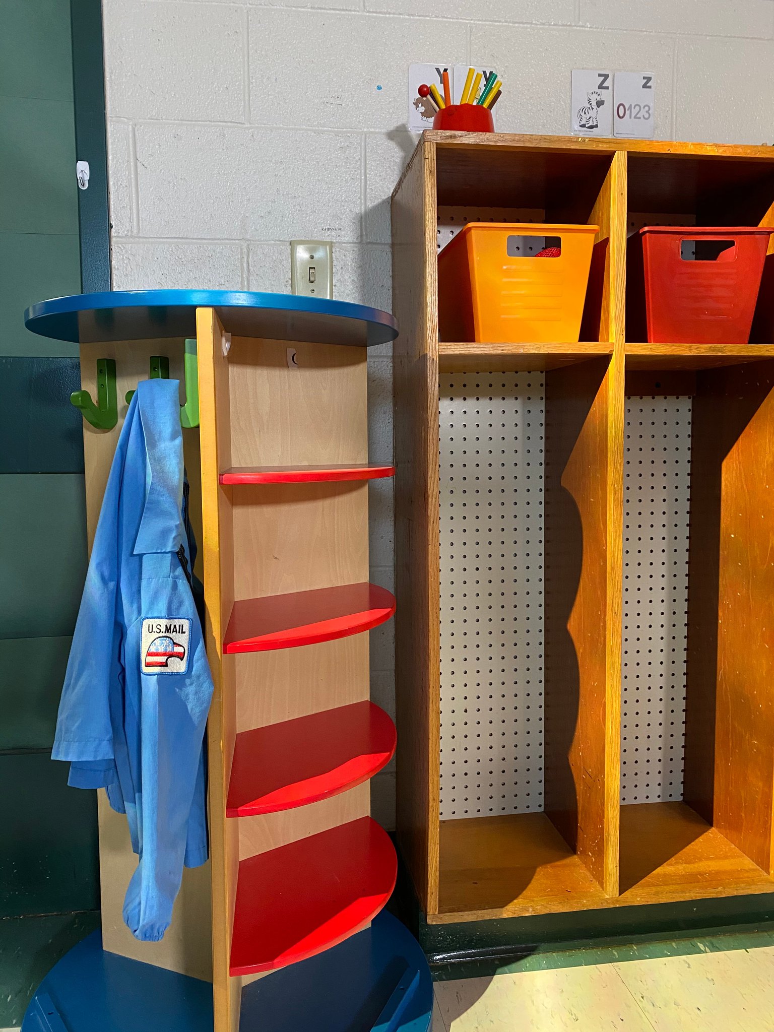 A post officer uniform hung in a classroom.