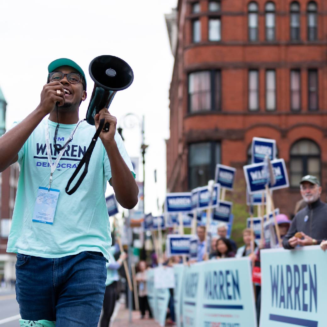 Man wearing EW gear blowing into a whistle