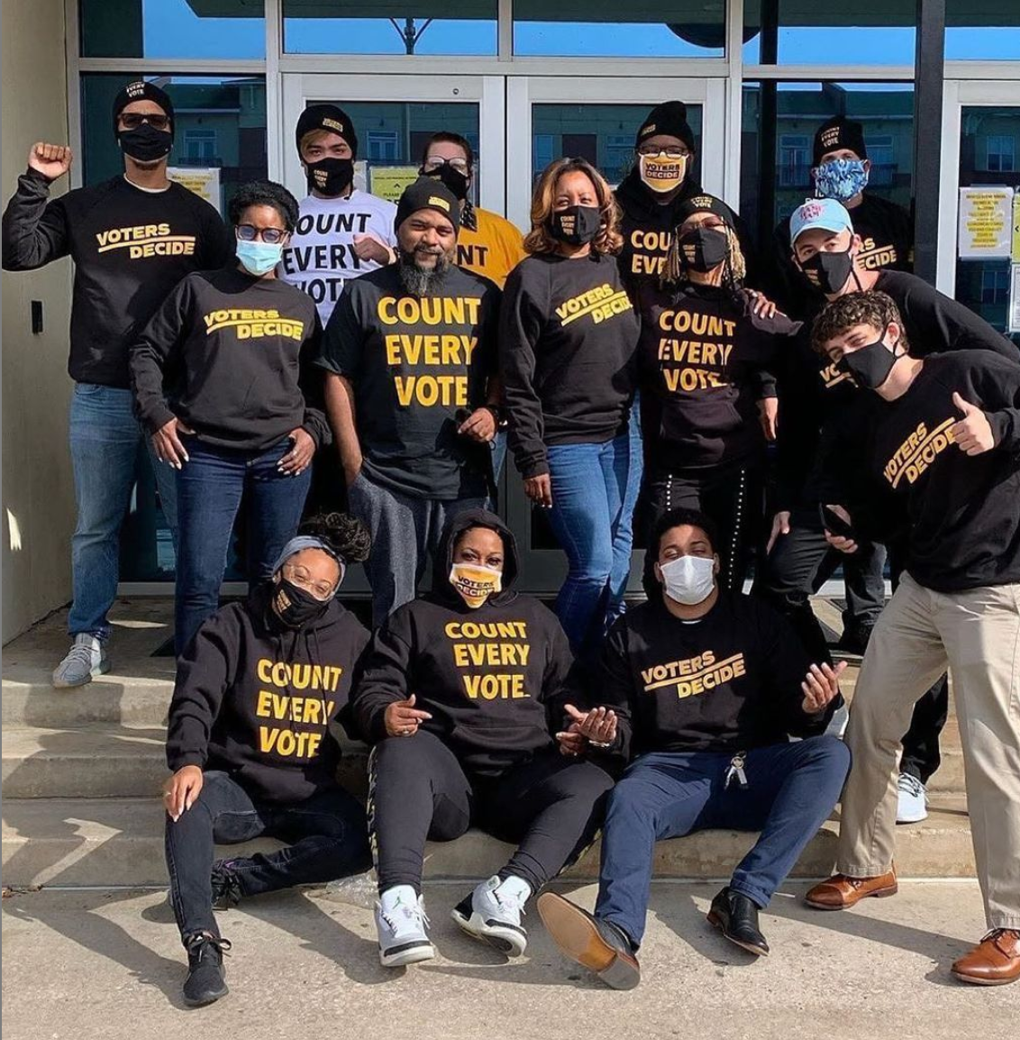 Group of protestors holding and wearing 